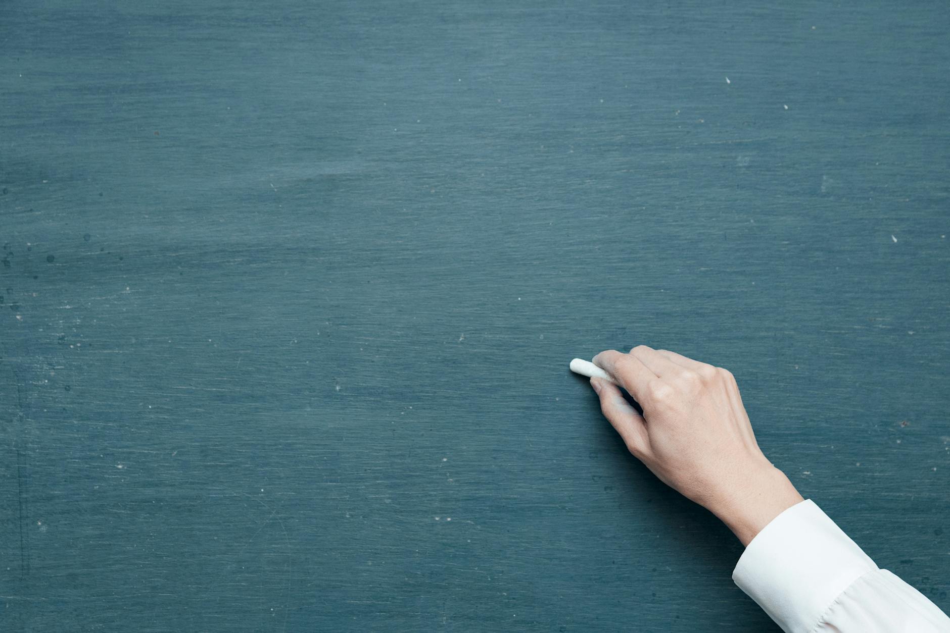 person holding white chalk